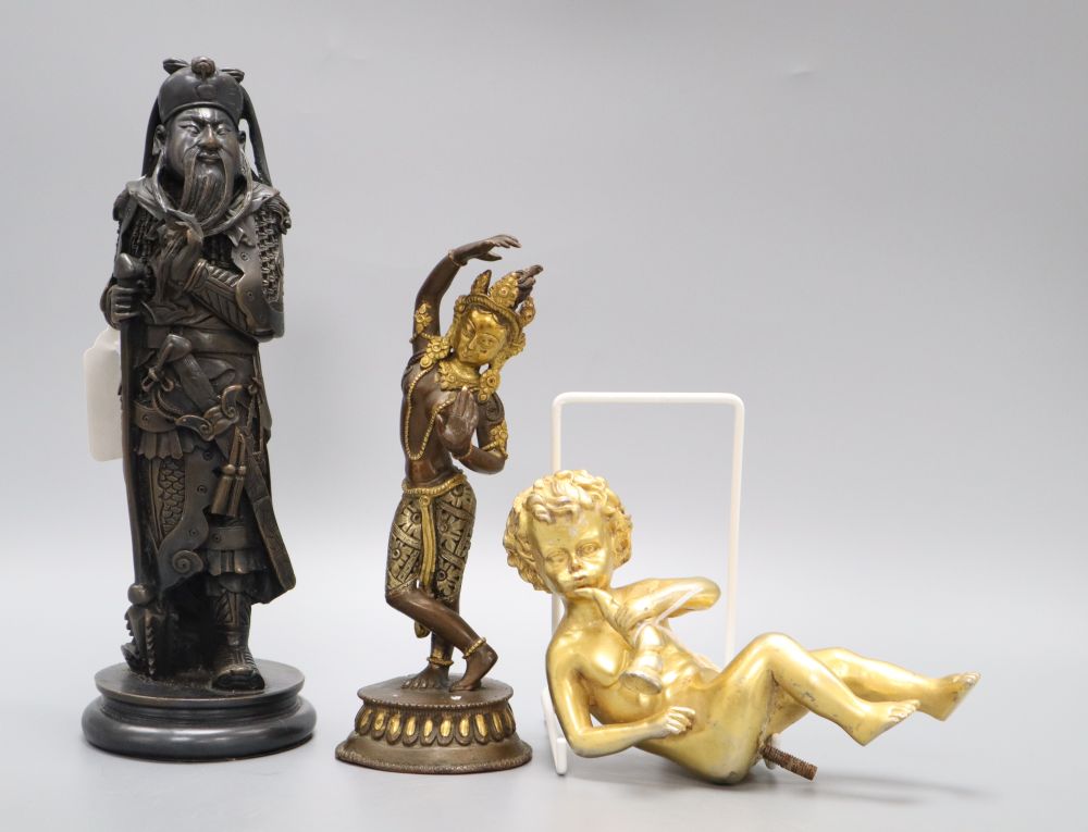 A gilt metal putti playing a musical conch shell, an Indian deity and a sage, tallest 26cm